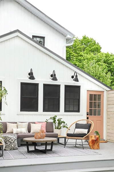An outdoor patio and deck set with seating and new overhead lights for a cozy exterior retreat
